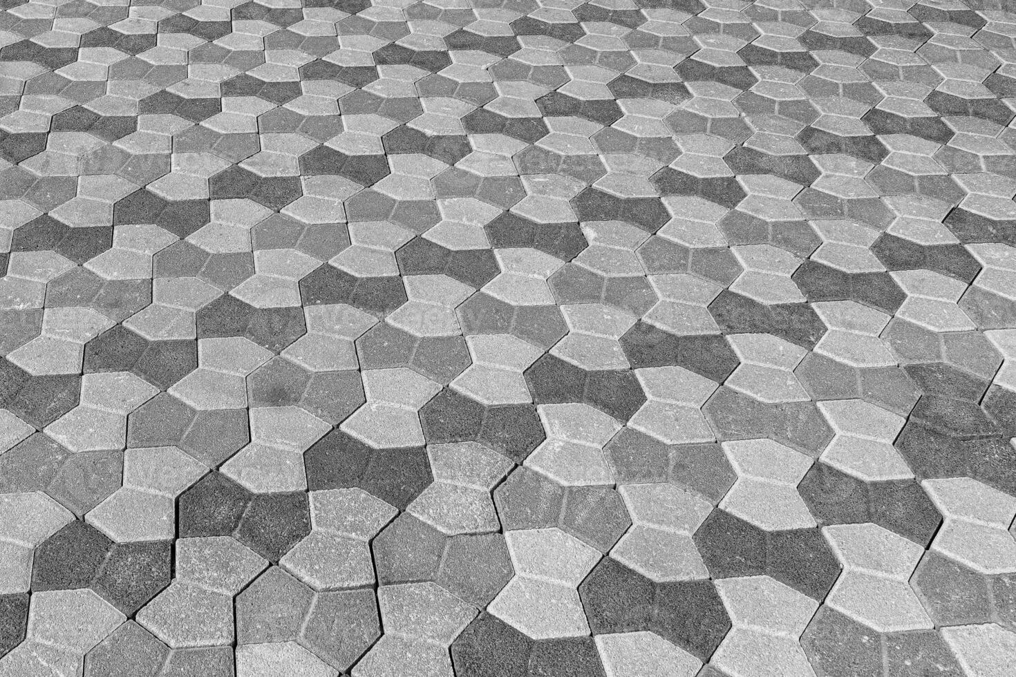 The texture of a stone old pavement with a perspective. Black and white. photo