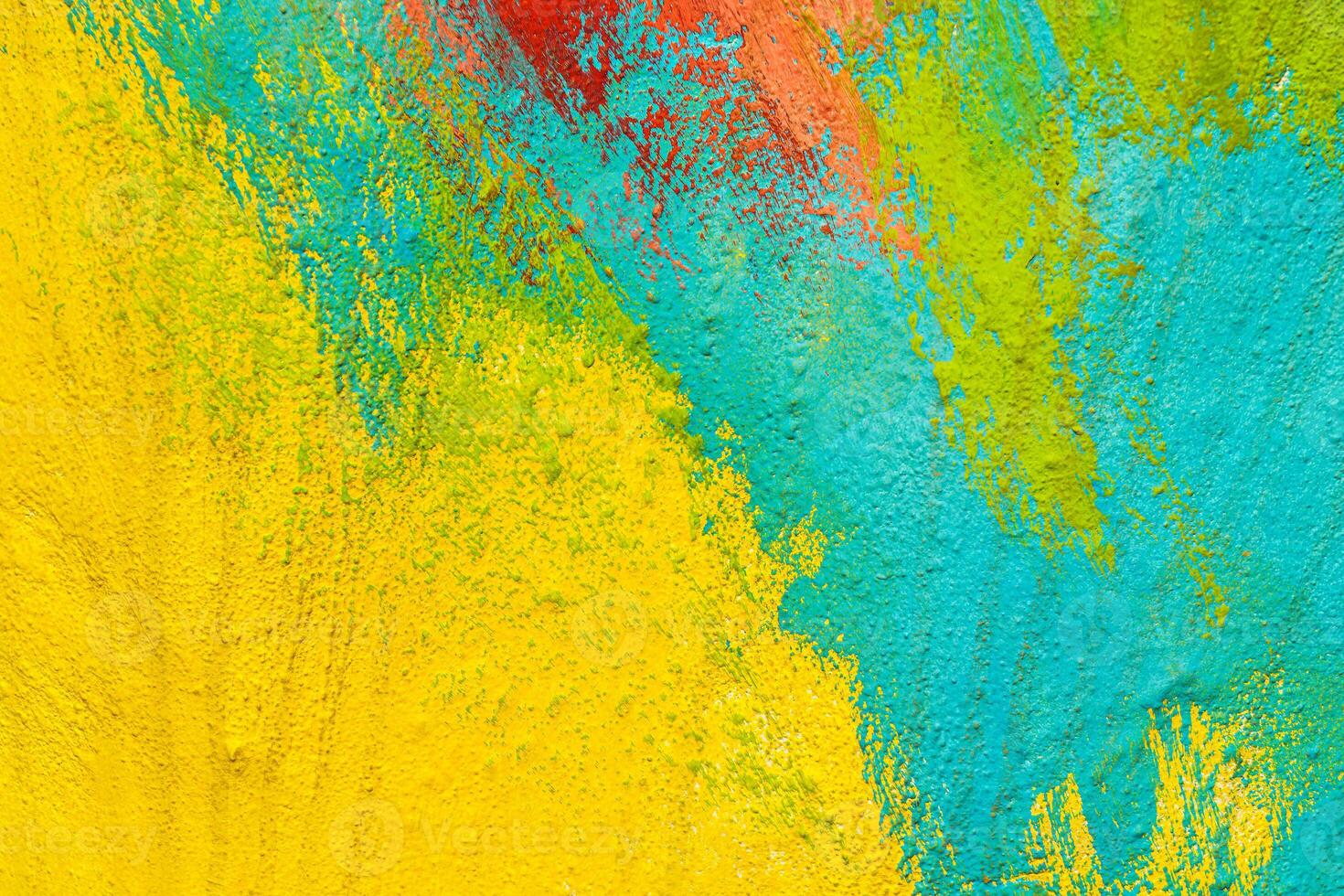 A fragment of colorful graffiti painted on a wall. Abstract urban background. Spray painting art. photo