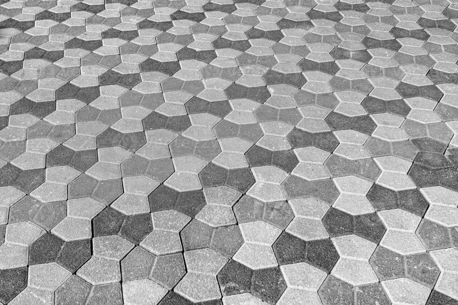 The texture of a stone old pavement with a perspective. Black and white. photo