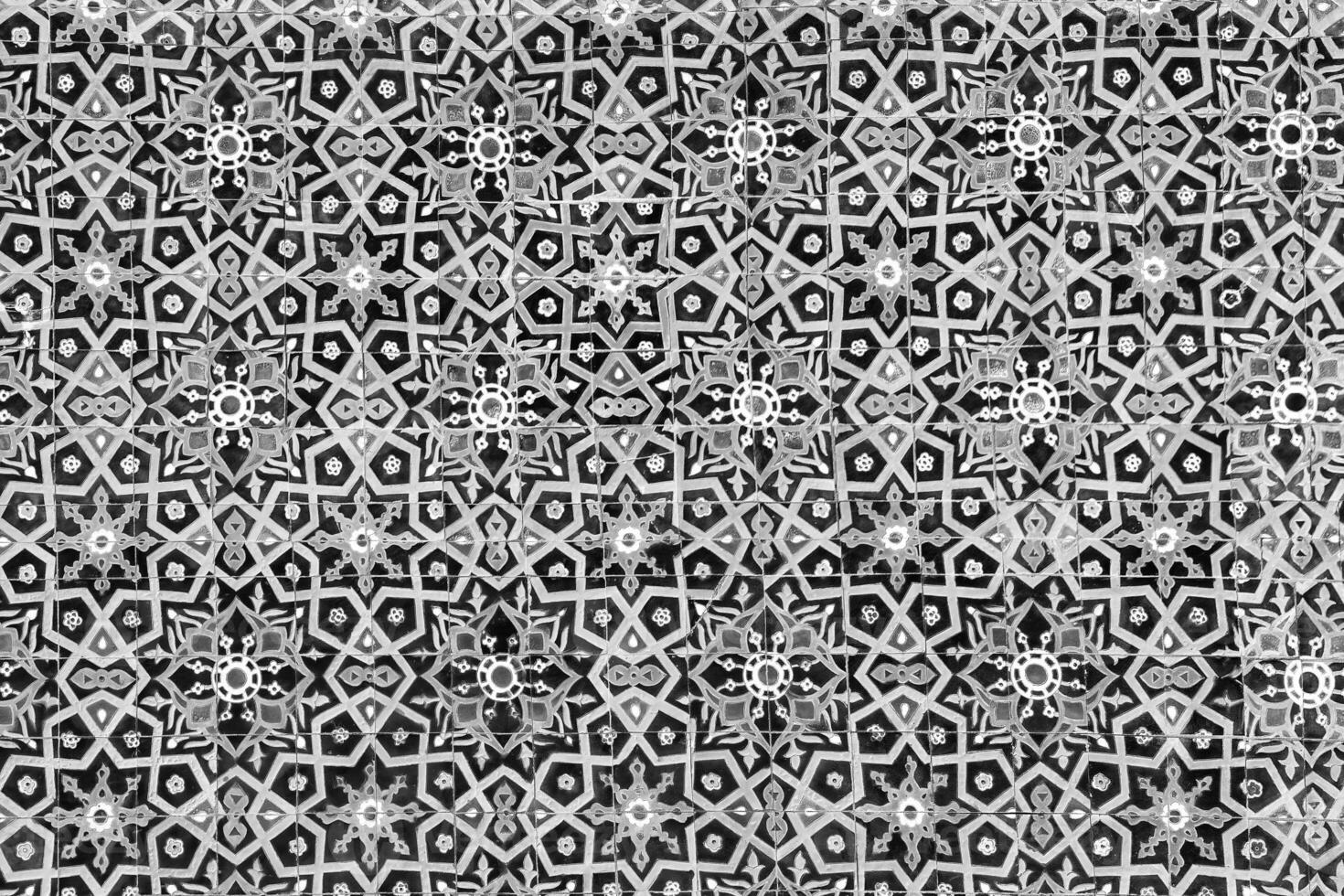 Geometric traditional Islamic ornament. Fragment of a ceramic mosaic. Black and white. photo