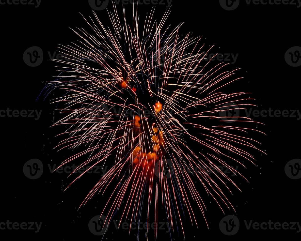Colorful celebration fireworks isolated on a black sky background. photo