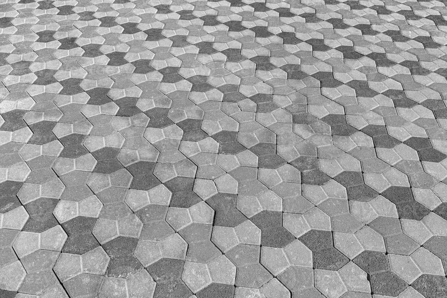 The texture of a stone old pavement with a perspective. Black and white. photo