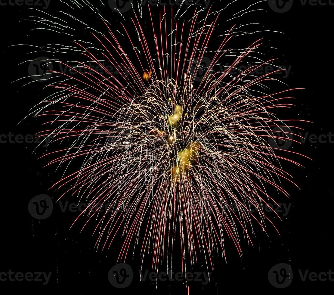 Colorful celebration fireworks isolated on a black sky background. photo