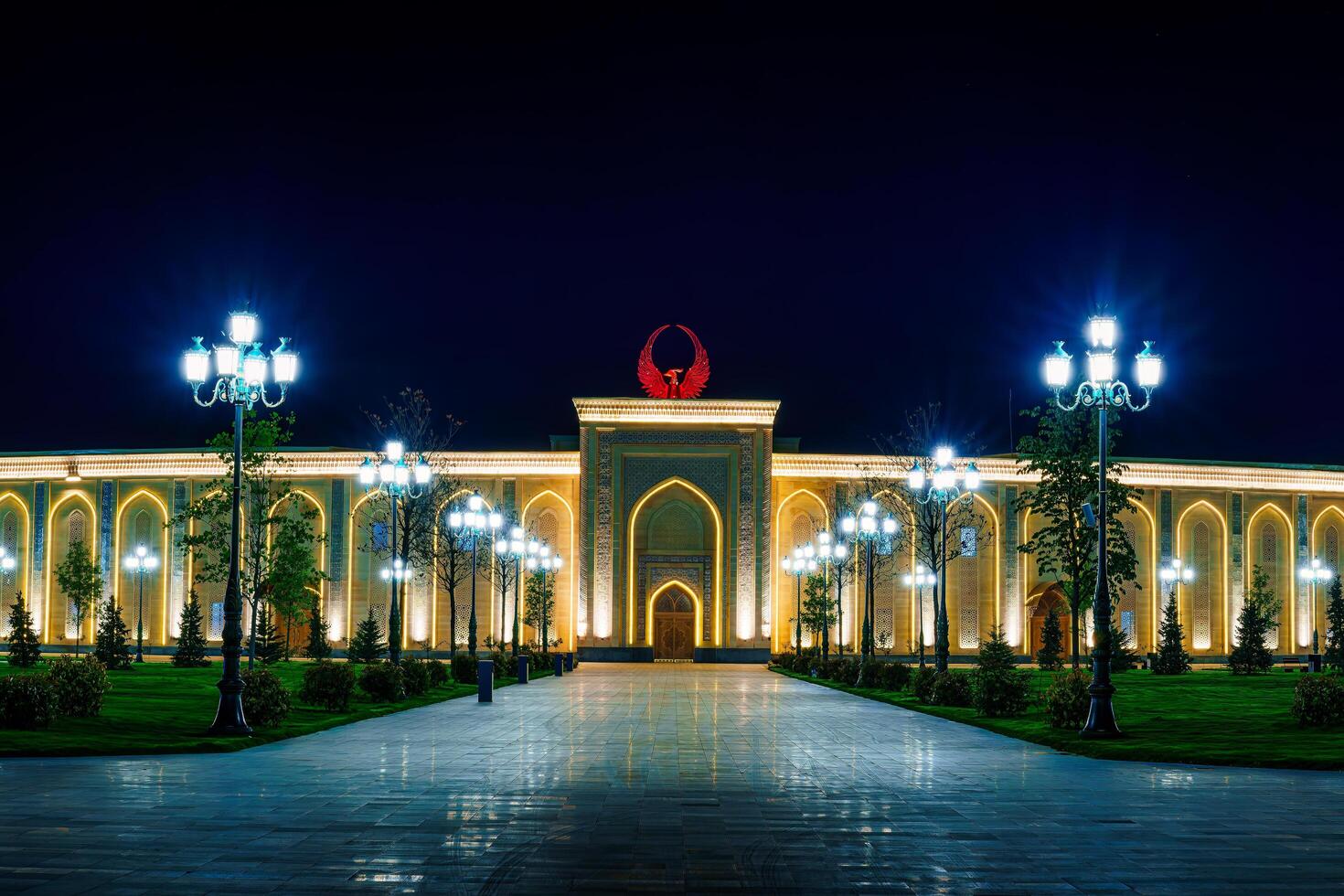 UZBEKISTAN, TASHKENT - APRIL 25, 2023 The territory of the park New Uzbekistan with Monument of Independence in the form of a stele with a Humo bird at night. photo
