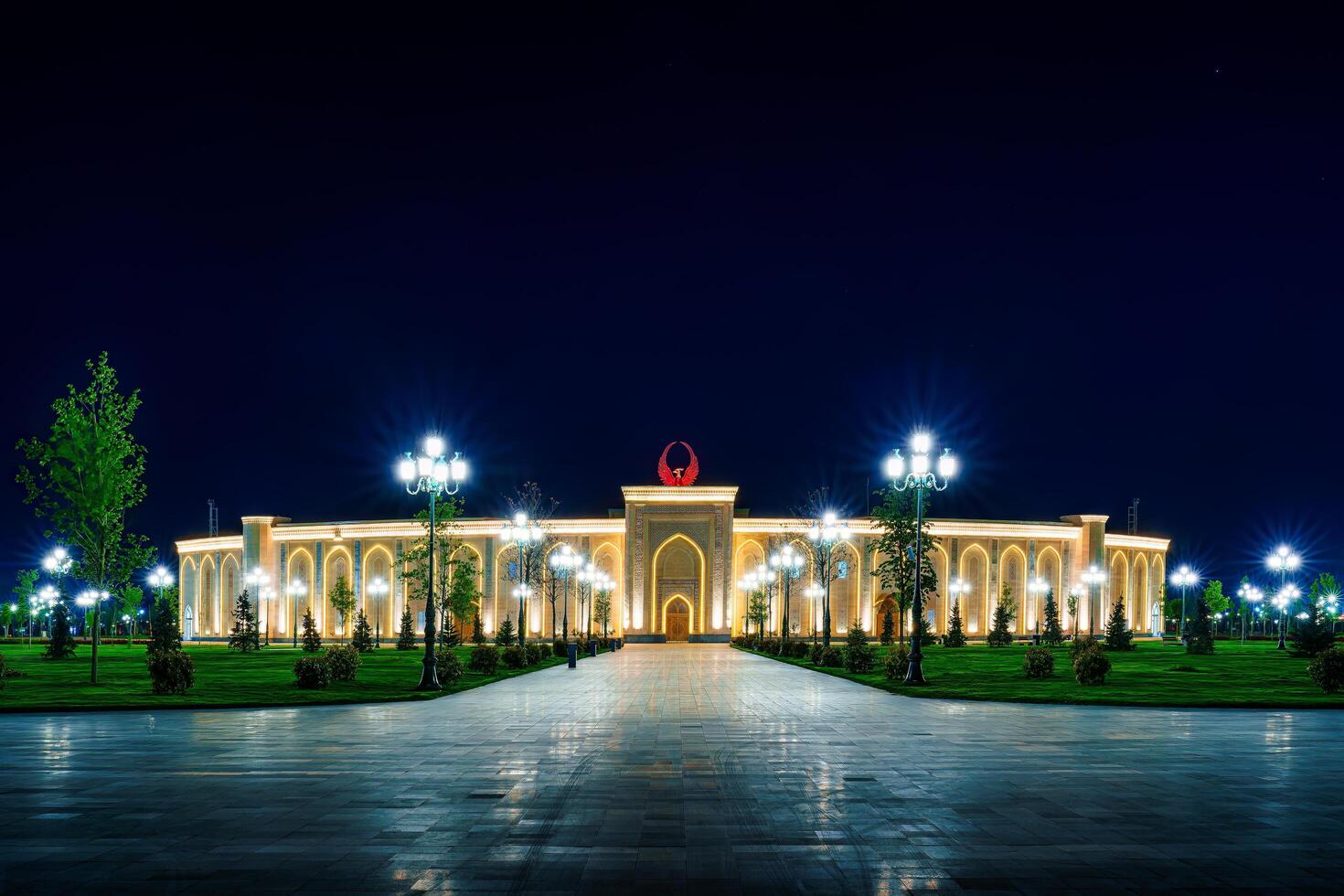 UZBEKISTAN, TASHKENT - APRIL 25, 2023 The territory of the park New Uzbekistan with Monument of Independence in the form of a stele with a Humo bird at night. photo