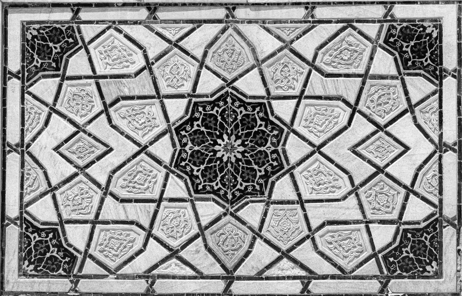 Geometric traditional Islamic ornament. Fragment of a ceramic mosaic. Black and white. photo