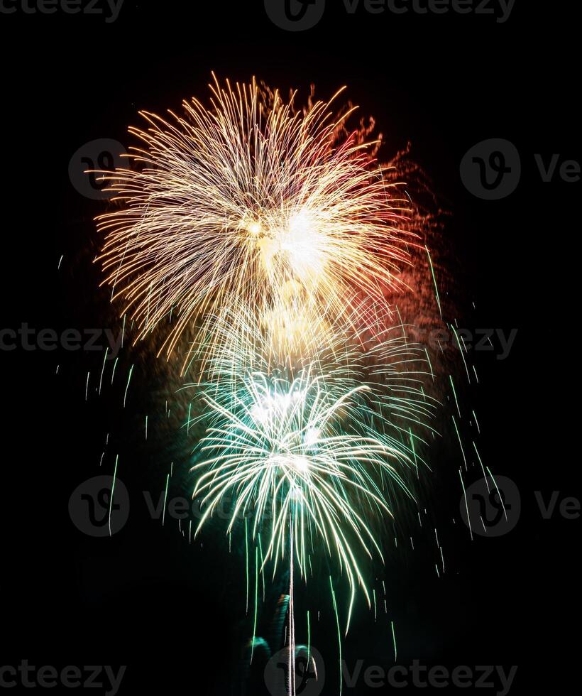 Colorful celebration fireworks isolated on a black sky background. photo