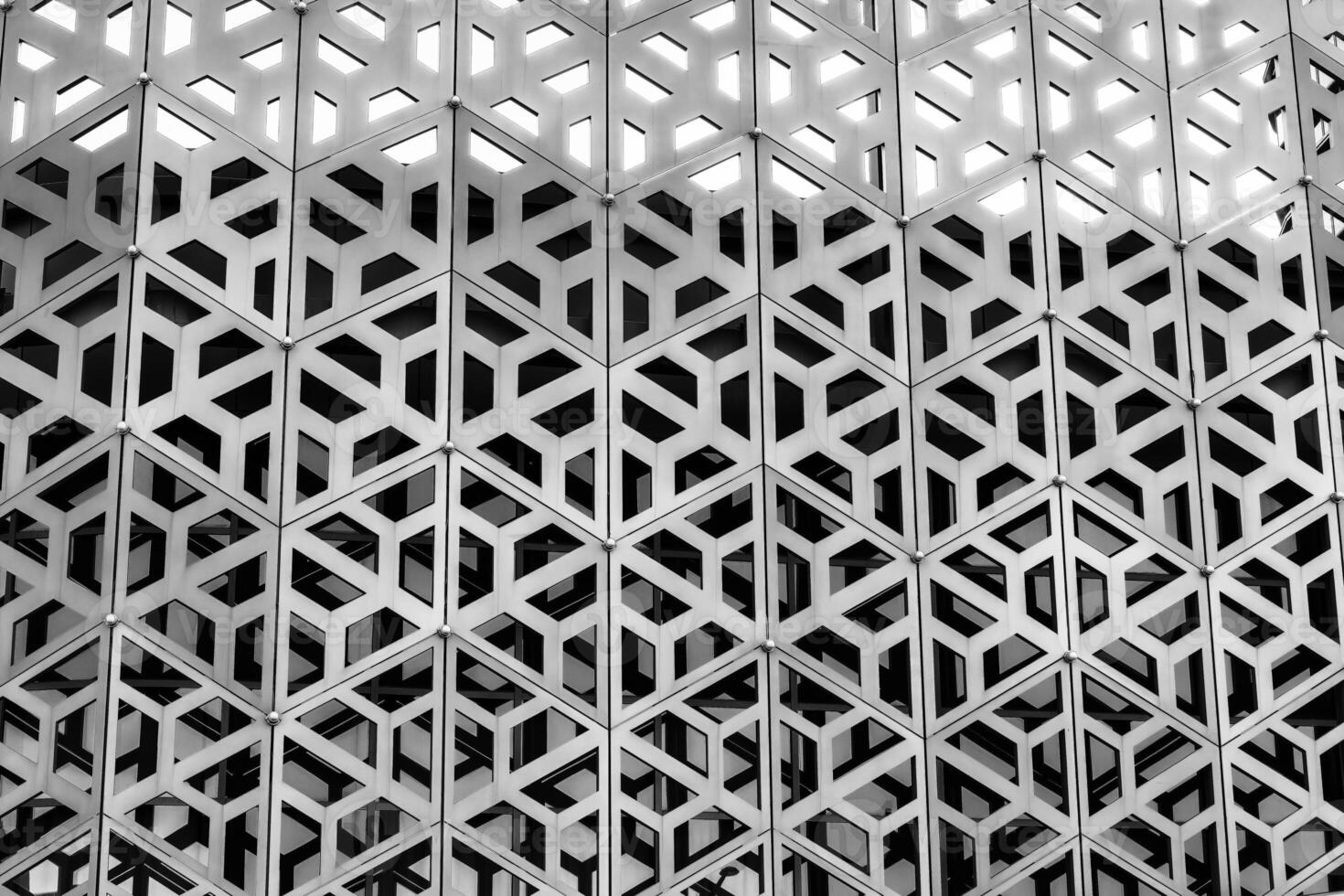 The texture of the cladding of a building made of metal aluminum panels with a carved pattern. Abstract background. Black and white. photo