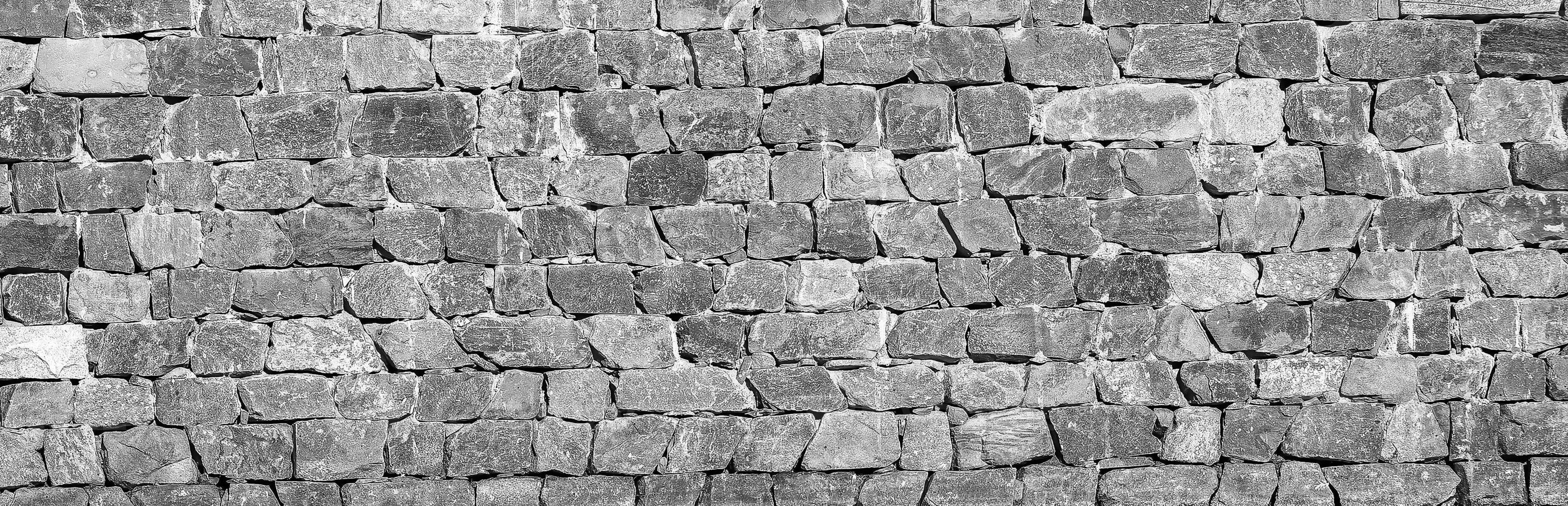 Black and white Texture of an old antique stone wall. Abstract background. photo