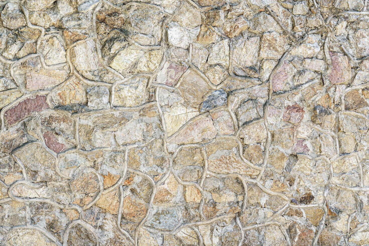 Decorative wall from stones and concrete. Abstract background. photo