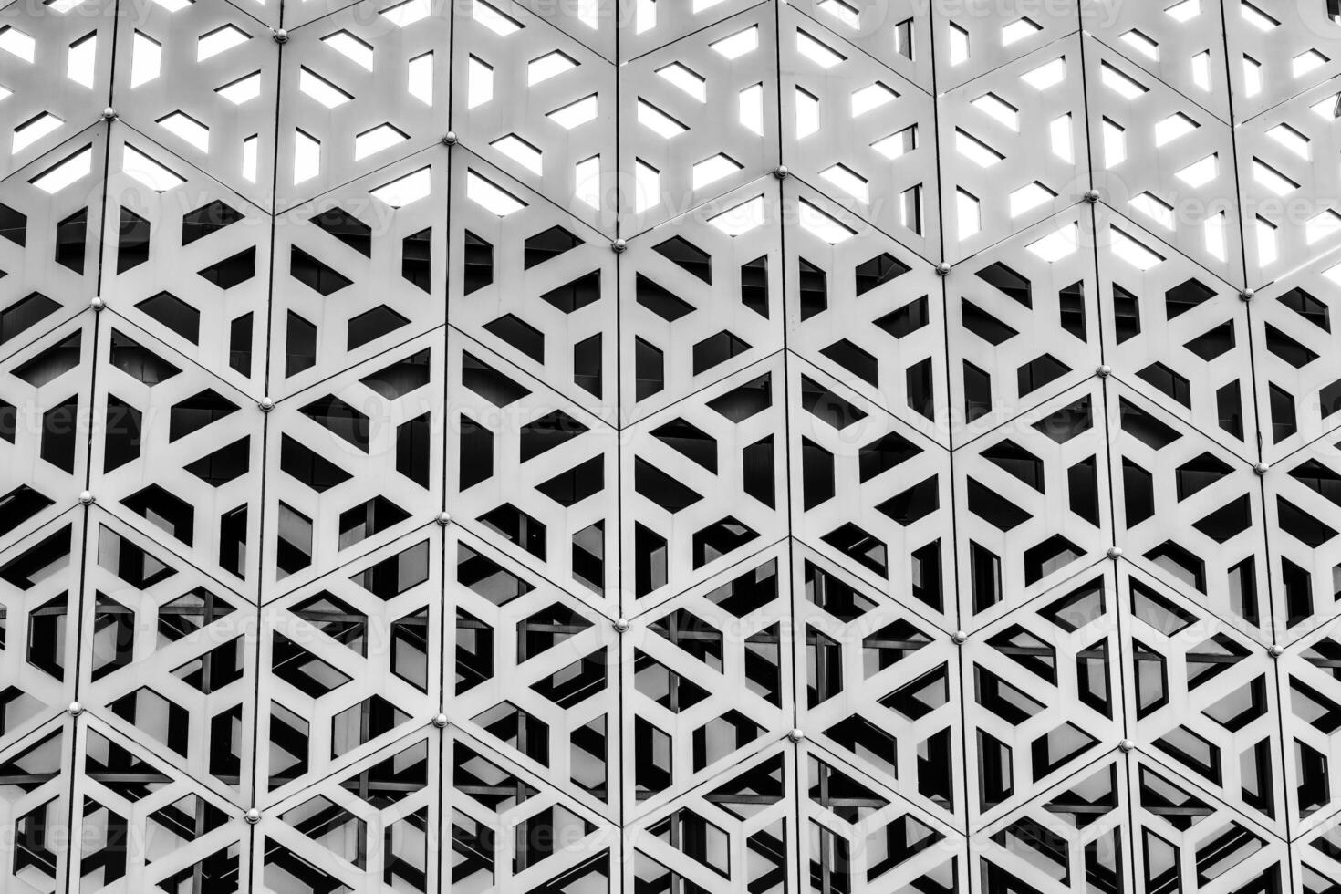 The texture of the cladding of a building made of metal aluminum panels with a carved pattern. Abstract background. Black and white. photo