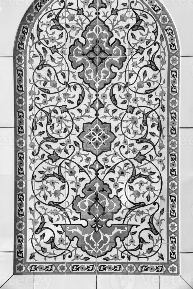 Black and white geometric traditional Islamic ornament on a tile. Fragment of a ceramic mosaic.Abstract background. photo