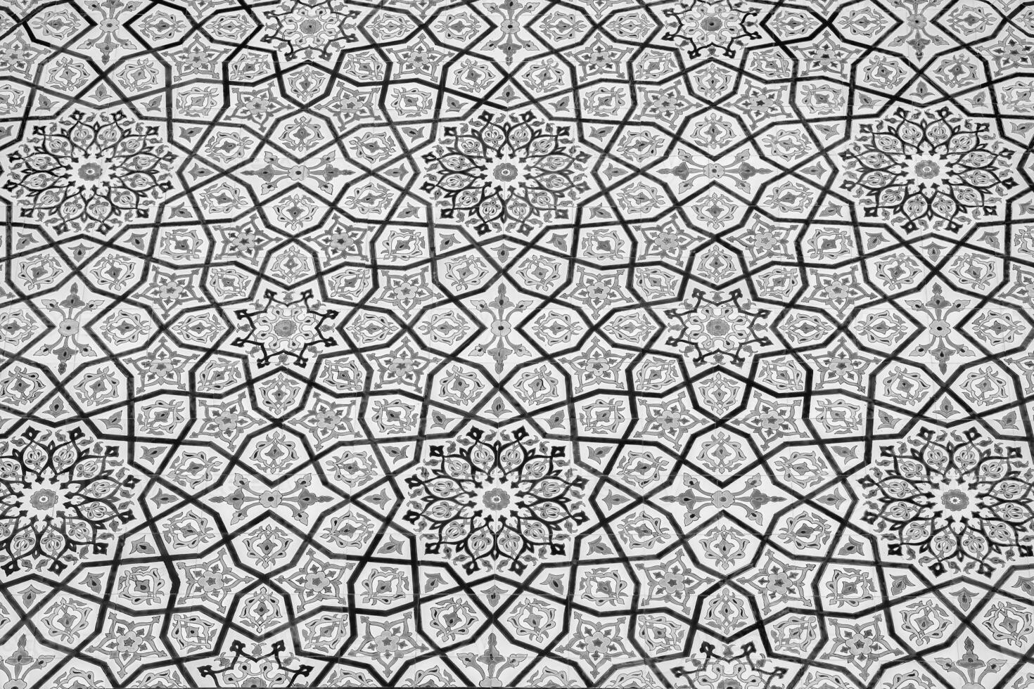 Black and white geometric traditional Islamic ornament on a tile. Fragment of a ceramic mosaic.Abstract background. photo