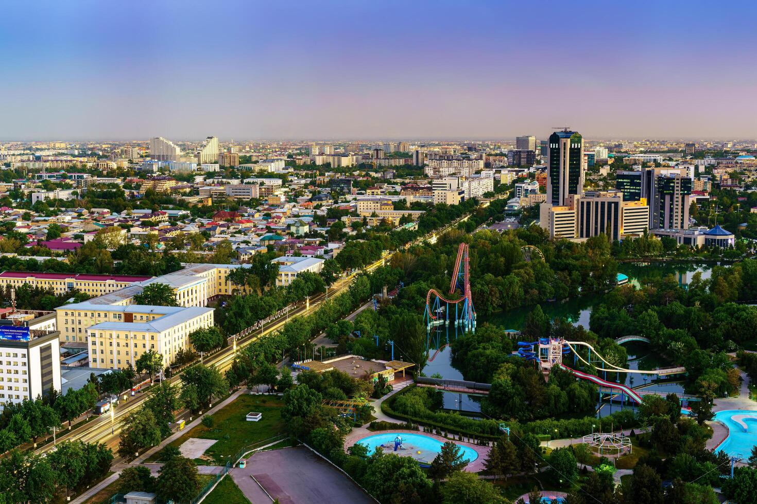 Uzbekistan, Tashkent - April 24, 2023 Top view from the observation deck on the Tashkent TV tower to the central part of the city during the twilight. photo