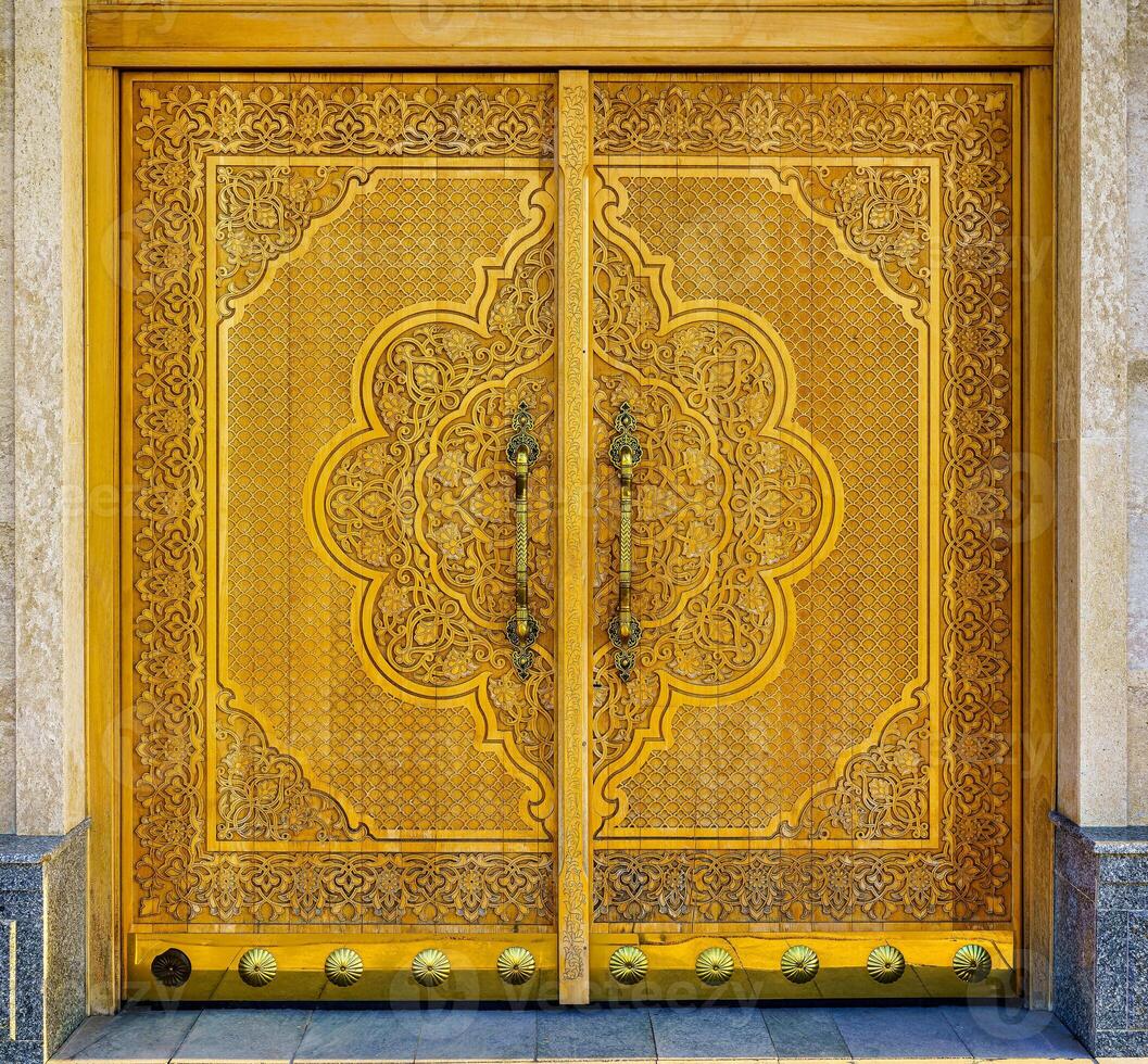 Carved wooden doors with patterns and mosaics. photo