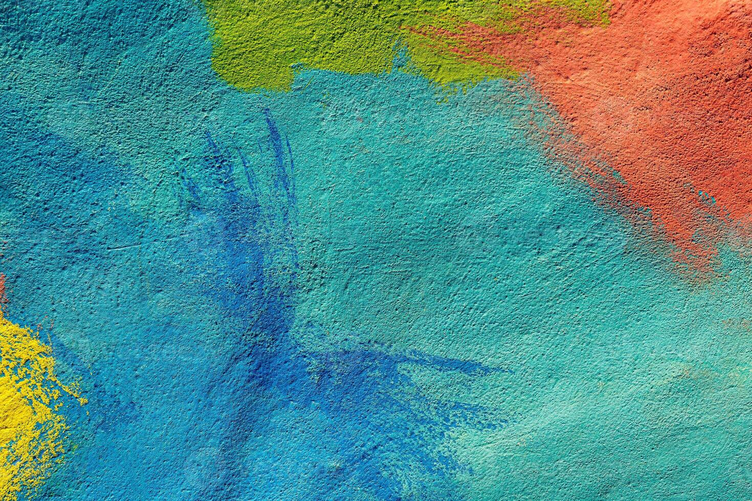 A fragment of colorful graffiti painted on a wall. Abstract urban background. Spray painting art. photo