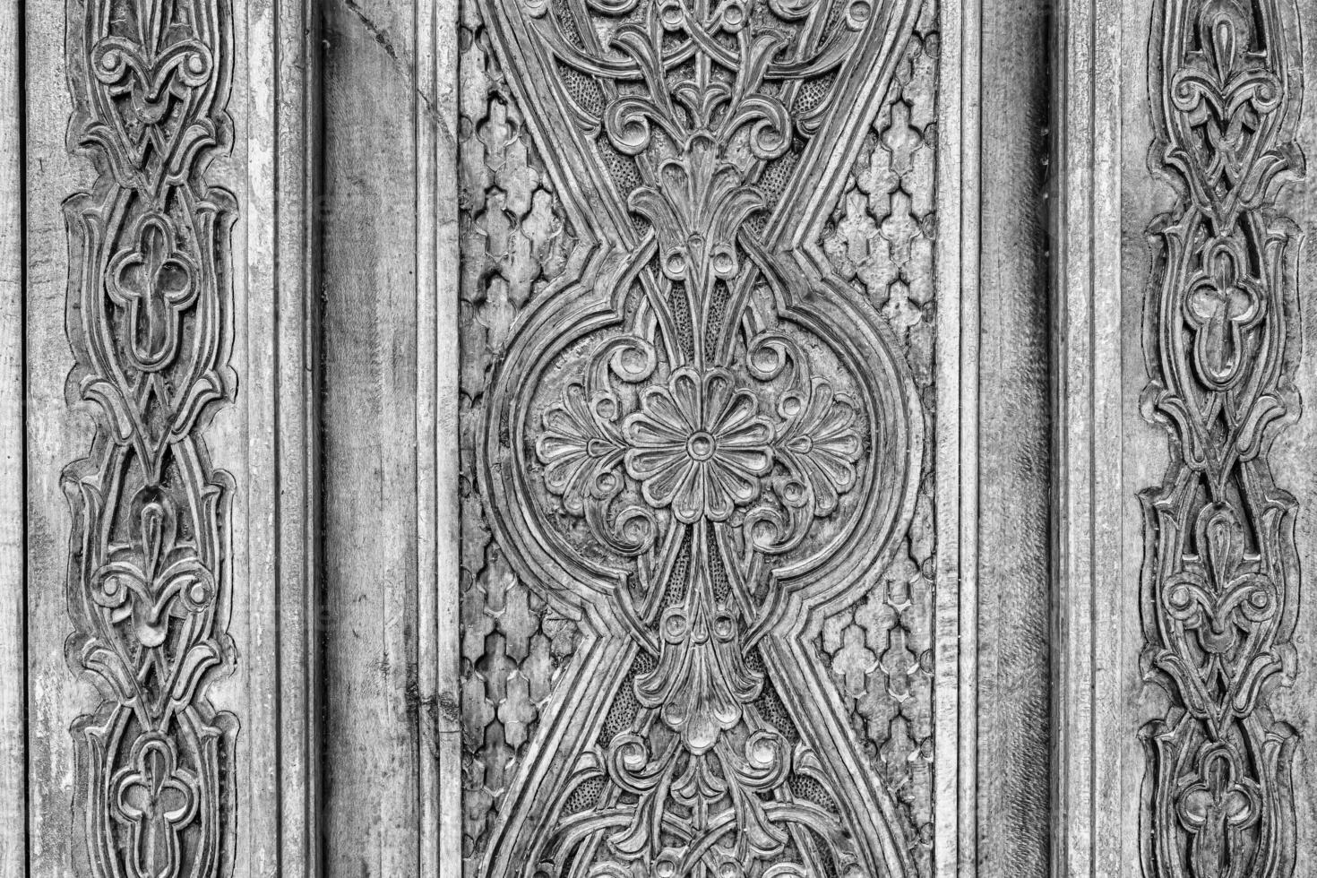 Black and white Carved wooden doors with patterns and mosaics. photo