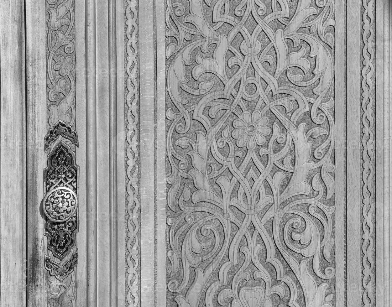 Black and white Carved wooden doors with patterns and mosaics. photo