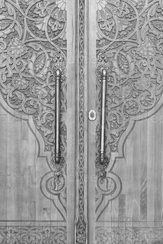 Black and white Carved wooden doors with patterns and mosaics. photo