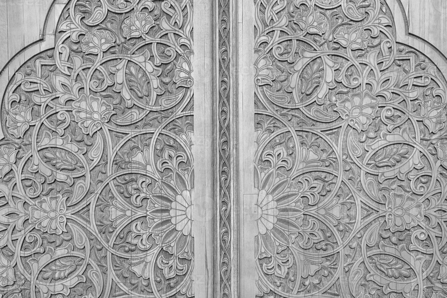 Black and white Carved wooden doors with patterns and mosaics. photo