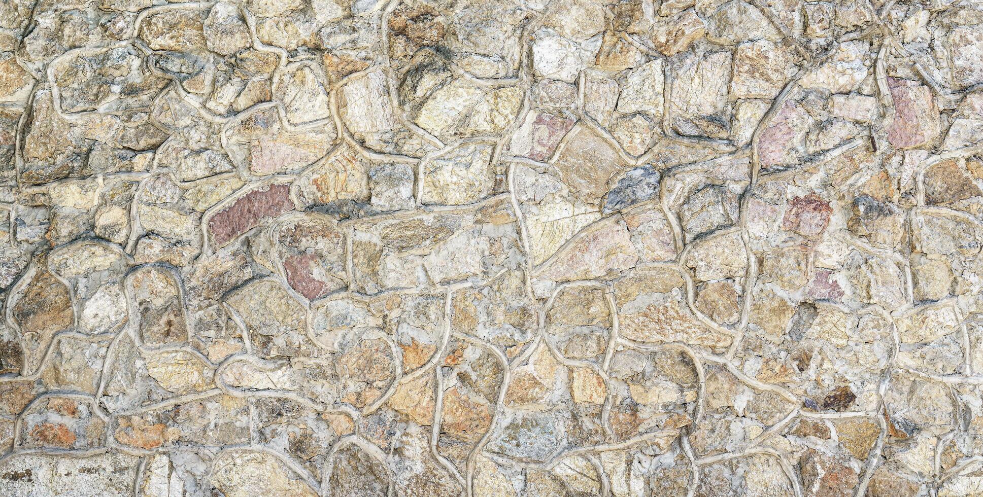 Decorative wall from stones and concrete. Abstract background. photo