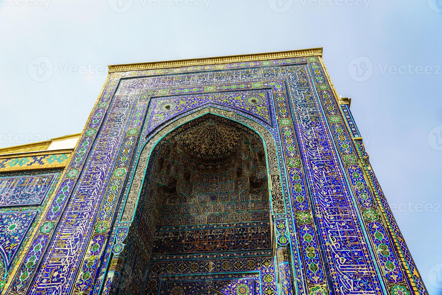 The ancient mausoleum of Shakh-I-Zinda, The Tomb of living King, during the reign of Amir Temur in Samarkand. Necropolis arch decorated with geometric Islamic oriental ornament. photo