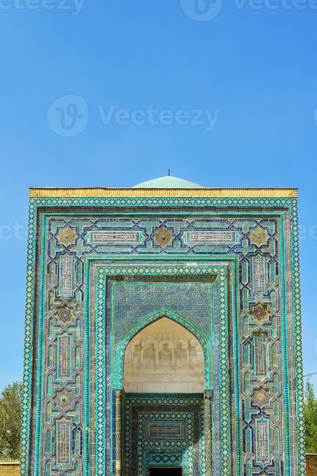 The ancient mausoleum of Shakh-I-Zinda, The Tomb of living King, during the reign of Amir Temur in Samarkand. Necropolis arch decorated with geometric Islamic oriental ornament. photo