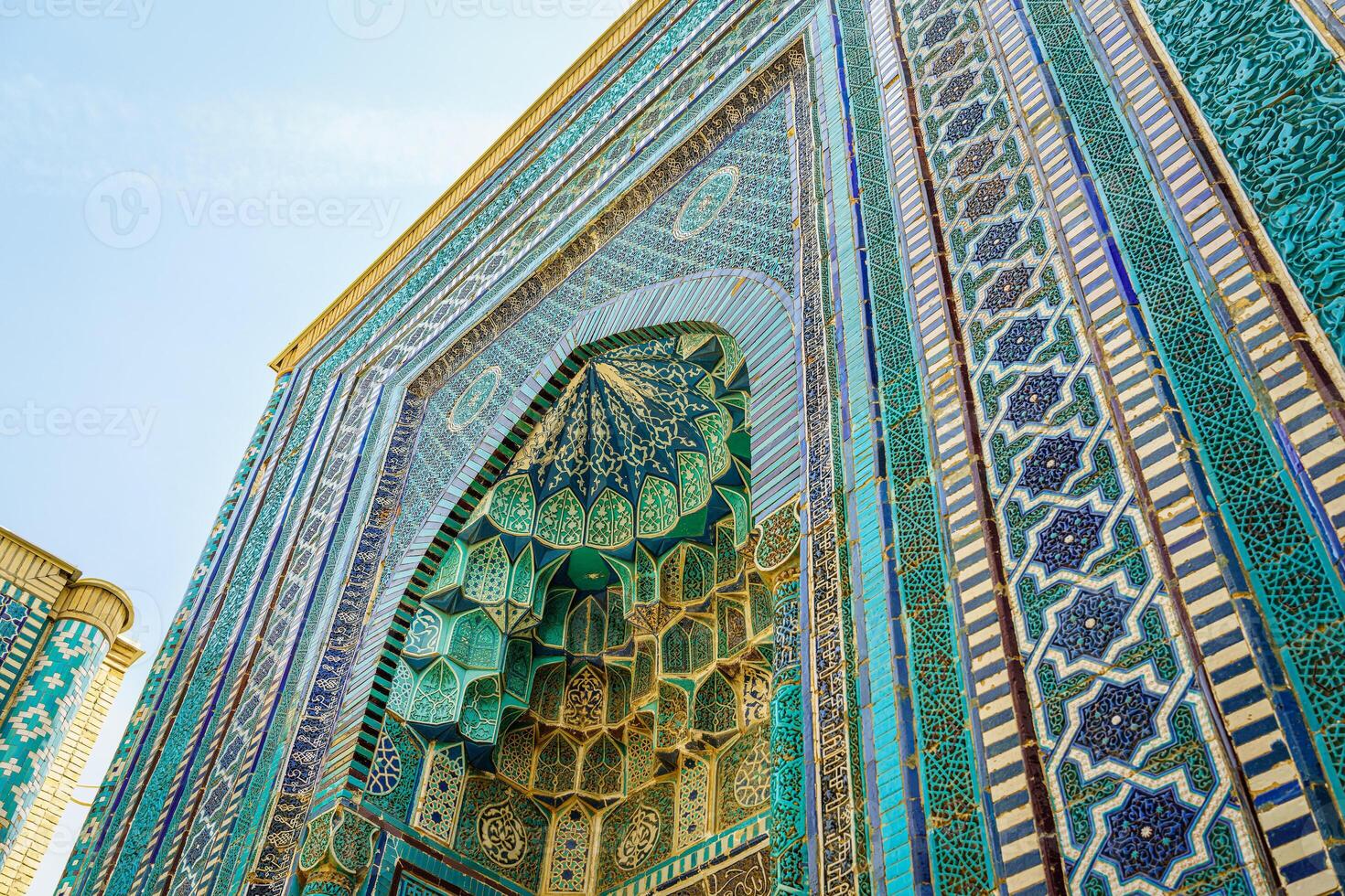 The ancient mausoleum of Shakh-I-Zinda, The Tomb of living King, during the reign of Amir Temur in Samarkand. Necropolis arch decorated with geometric Islamic oriental ornament. photo