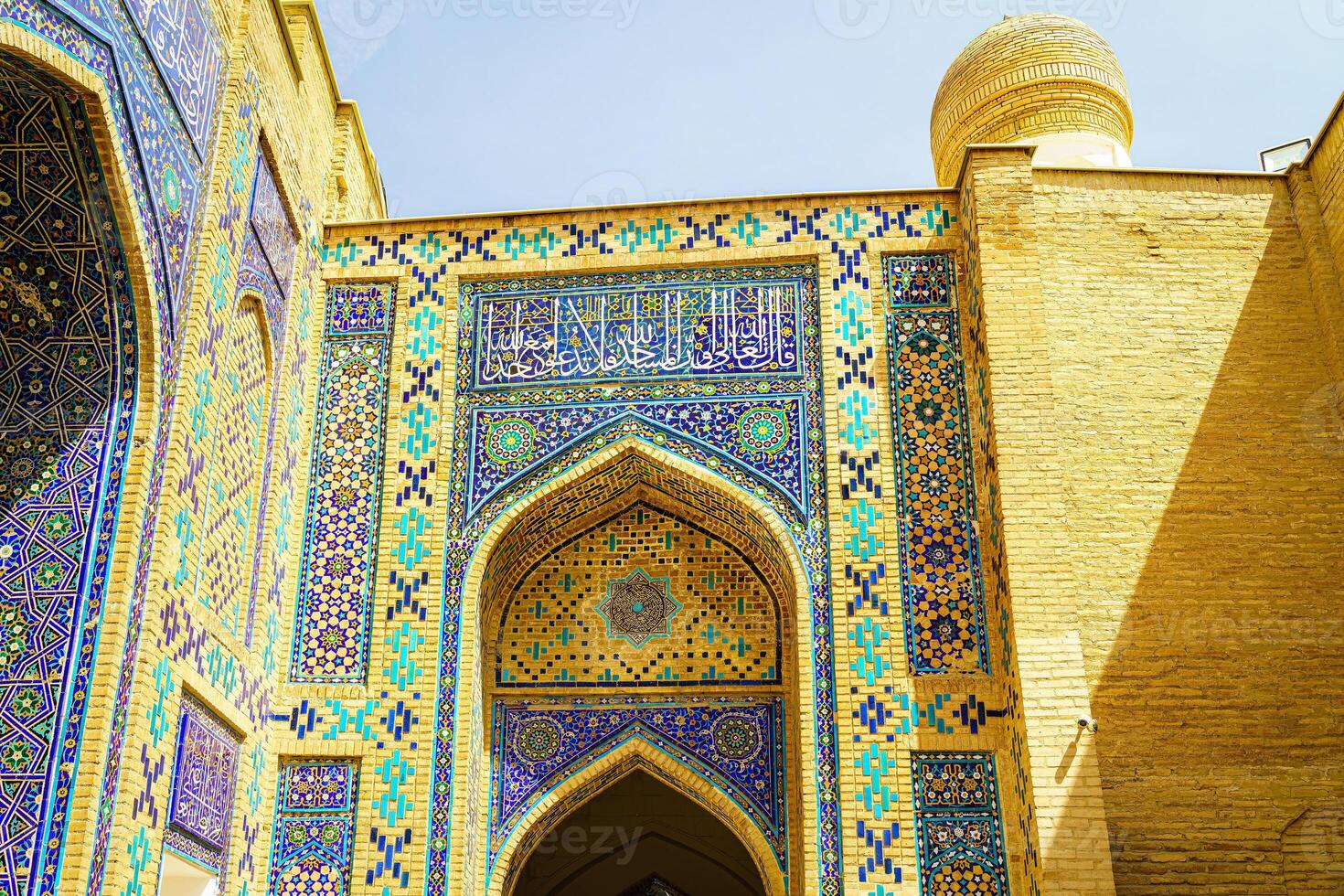 The ancient mausoleum of Shakh-I-Zinda, The Tomb of living King, during the reign of Amir Temur in Samarkand. Necropolis arch decorated with geometric Islamic oriental ornament. photo