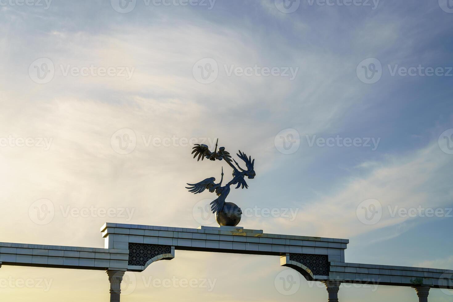 Independence Memorial at Independence Square in Tashkent illuminated at sunset. photo