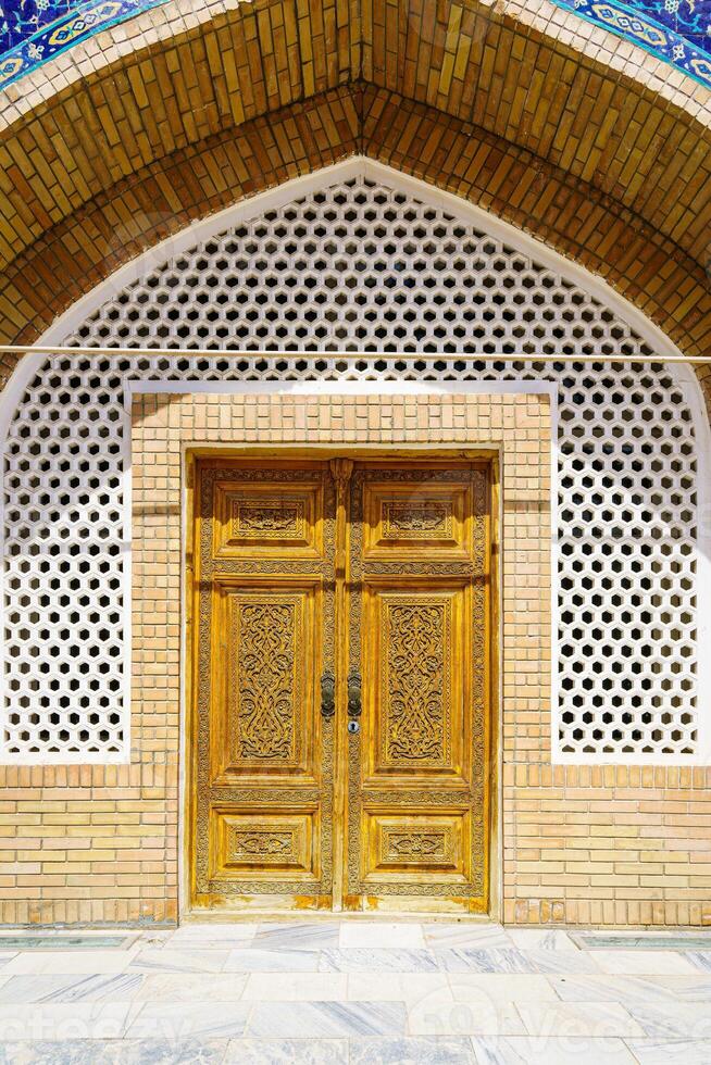 Carved wooden doors with patterns and mosaics. photo