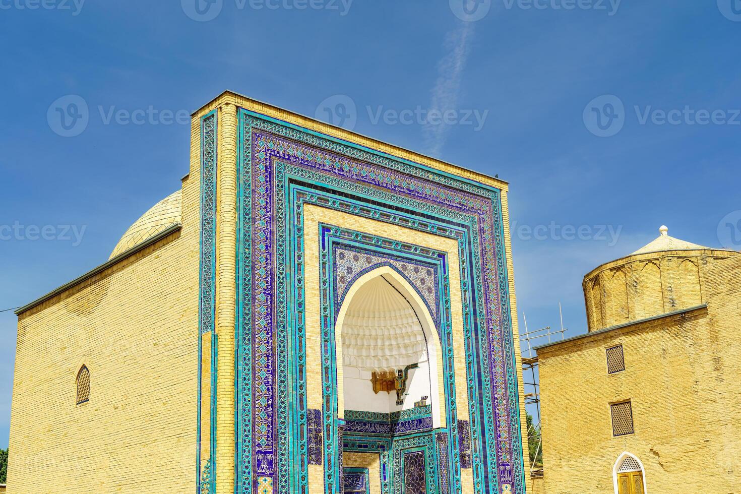 The ancient mausoleum of Shakh-I-Zinda, The Tomb of living King, during the reign of Amir Temur in Samarkand. Necropolis arch decorated with geometric Islamic oriental ornament. photo