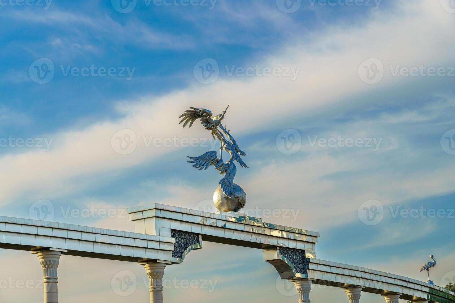 Independence Memorial at Independence Square in Tashkent illuminated at sunset. photo