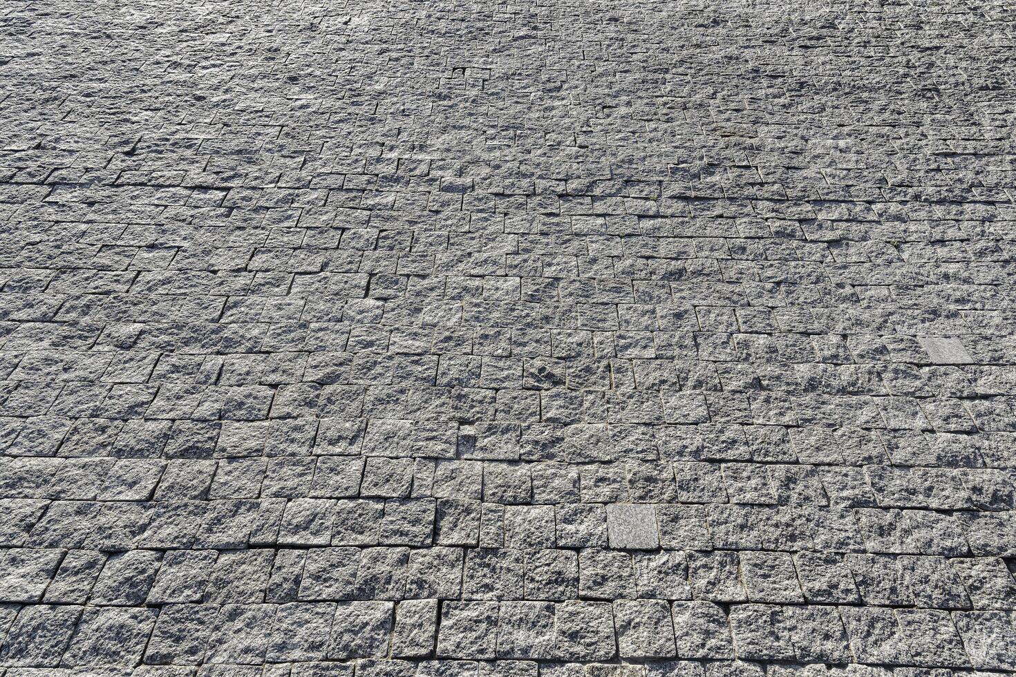 The texture of a stone old pavement with a perspective. photo