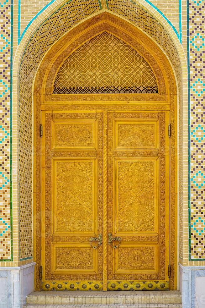 Carved wooden doors with patterns and mosaics. photo