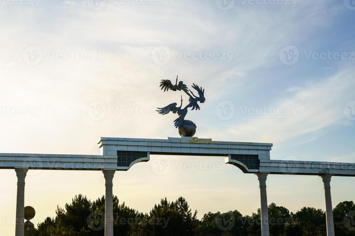 Independence Memorial at Independence Square in Tashkent illuminated at sunset. photo