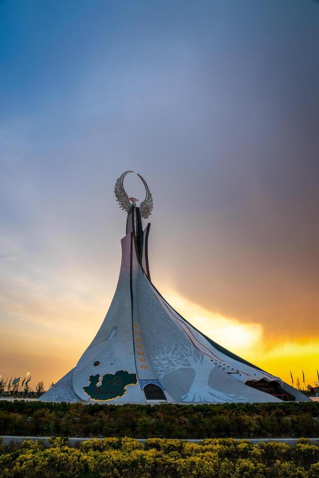 UZBEKISTAN, TASHKENT - APRIL 25, 2023 Monument of Independence in the form of a stele with a Humo bird on a sunset in the New Uzbekistan. photo