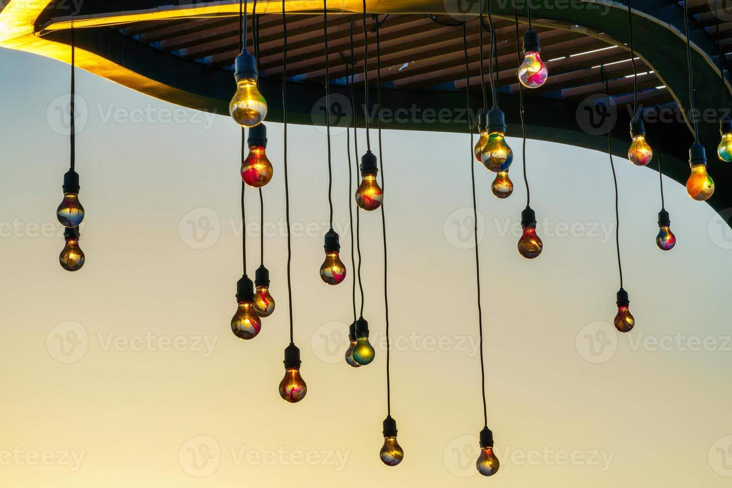 Festive hanging garlands with light bulbs against the background of a twilight sky. photo