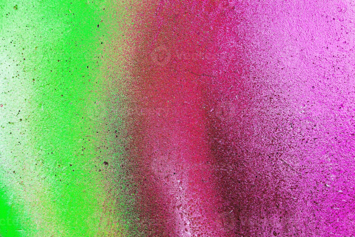 Colorful graffiti painted on a wall. Abstract urban background. Spray painting art. photo