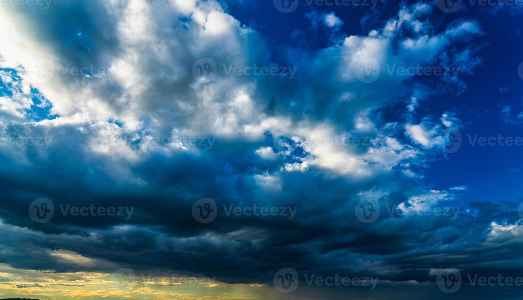 An approaching thunderstorm in a flowering rapeseed field. photo