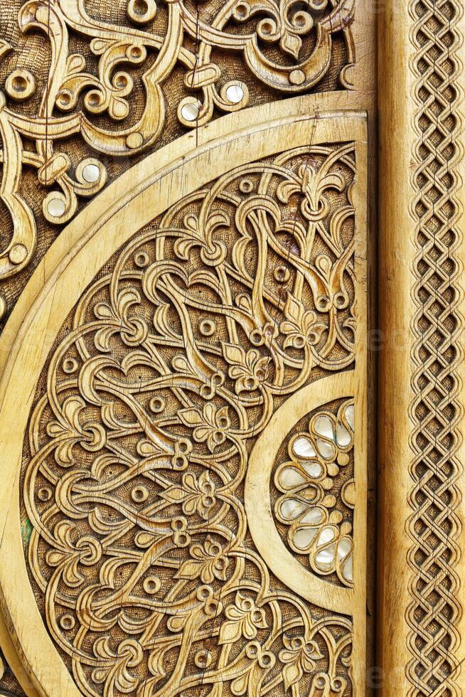Carved wooden doors with patterns and mosaics. photo