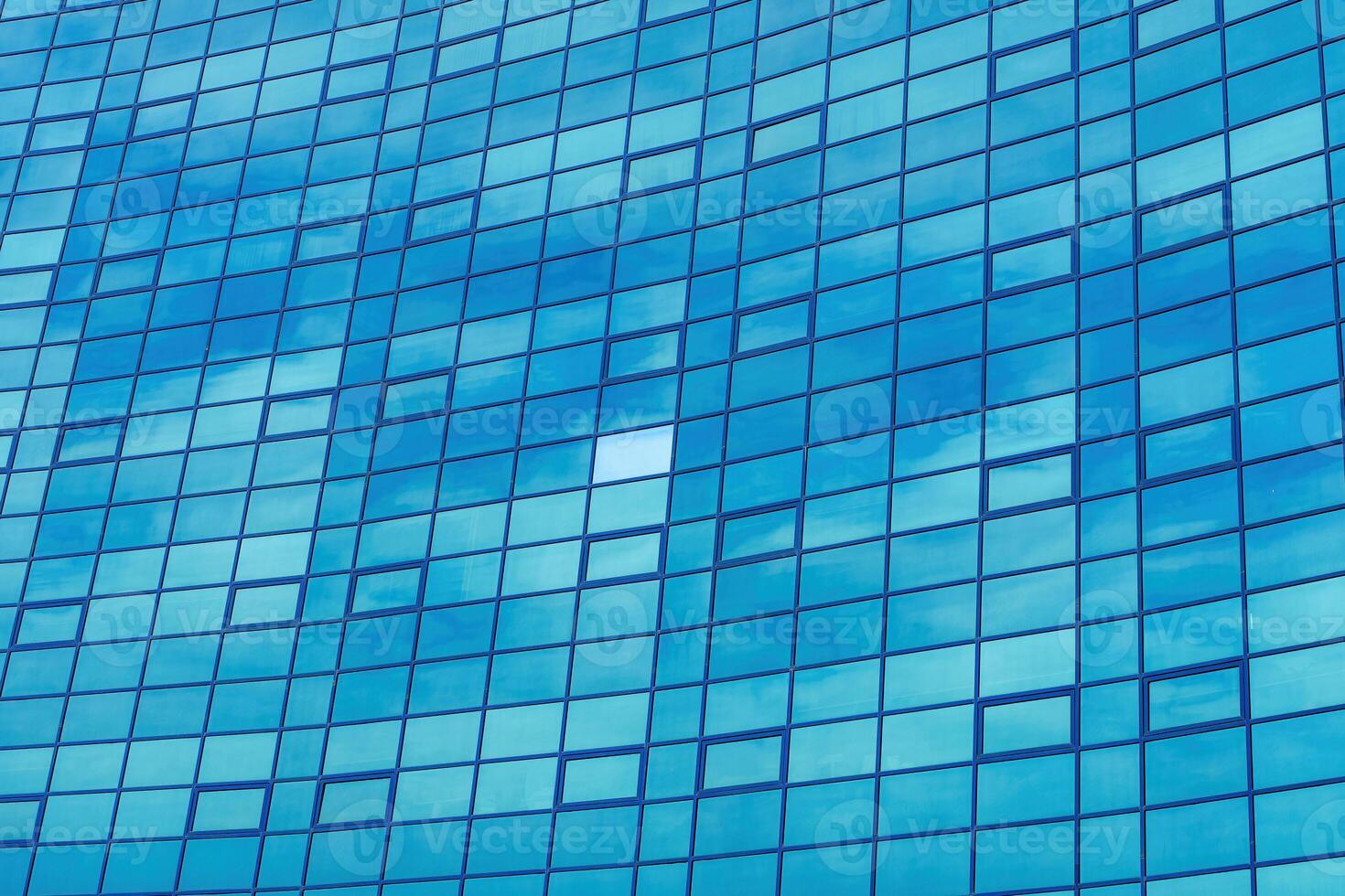 Fragment of a modern office building. Abstract geometric background. Part of the facade of a skyscraper with glass windows. photo