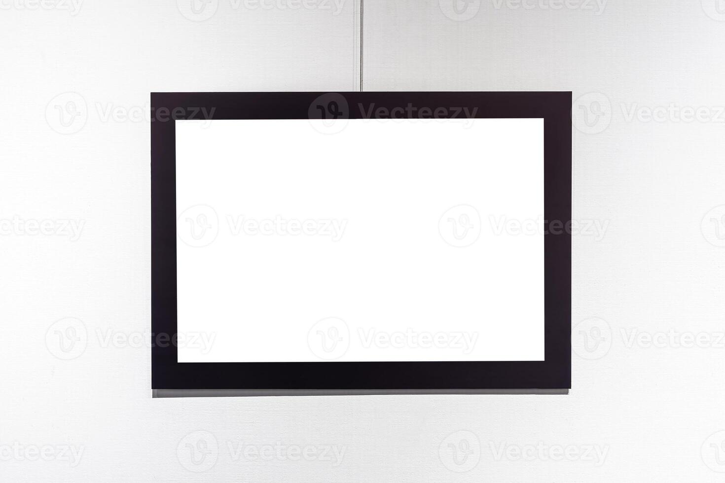 Picture frames with copy space for text hanging on the wall with wallpaper. Mockup for design. photo