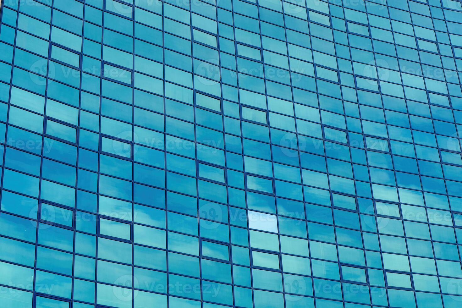 Fragment of a modern office building. Abstract geometric background. Part of the facade of a skyscraper with glass windows. photo