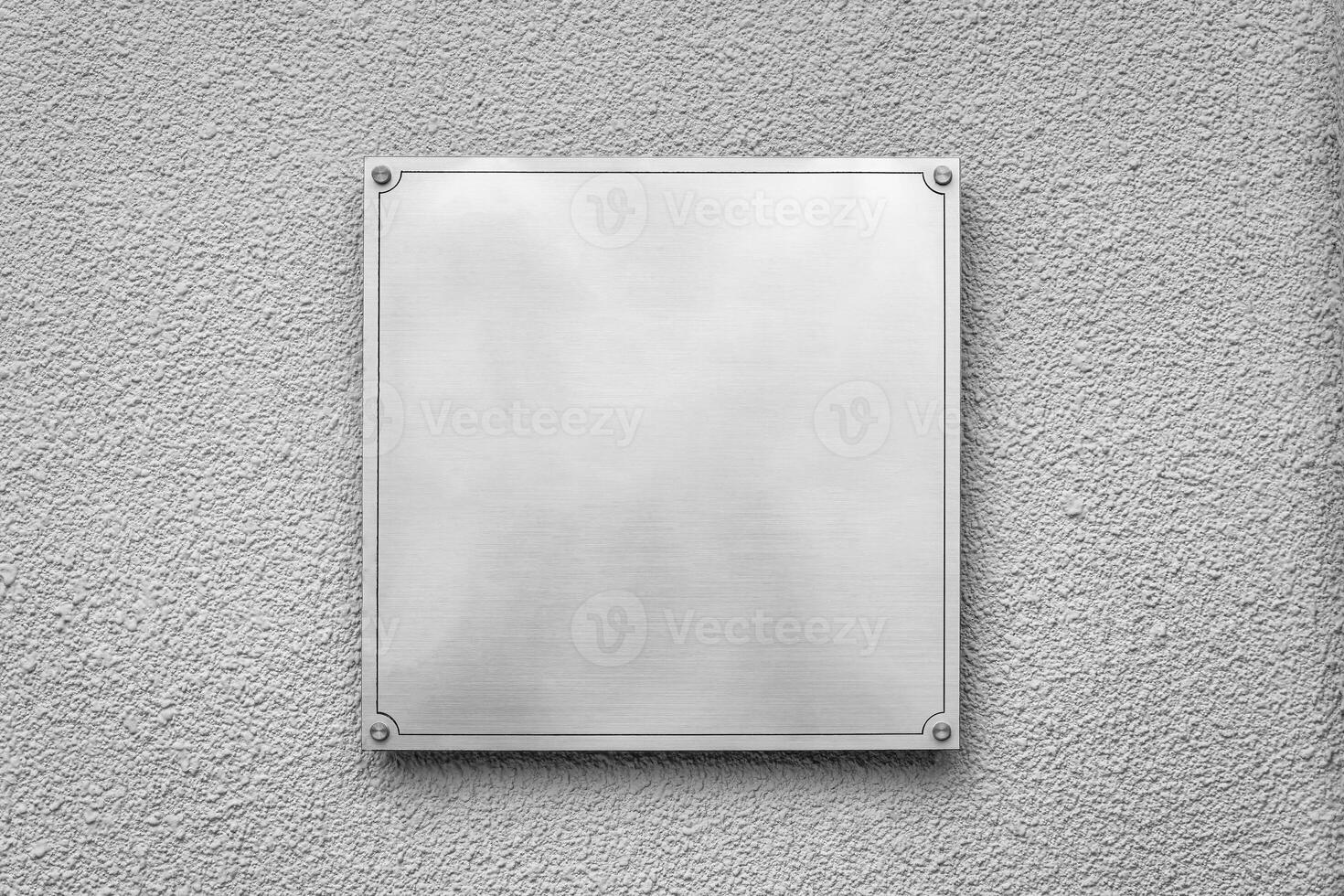 Steel square board with copyspace for text hanging on the wall. Mockup for design. photo