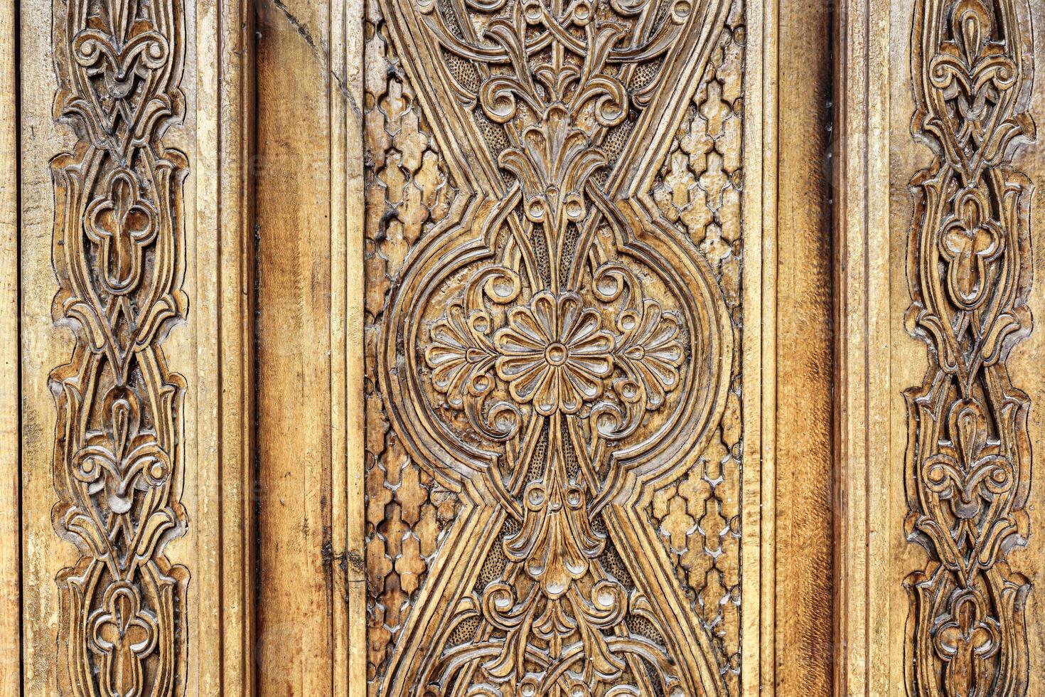 Carved wooden doors with patterns and mosaics. photo