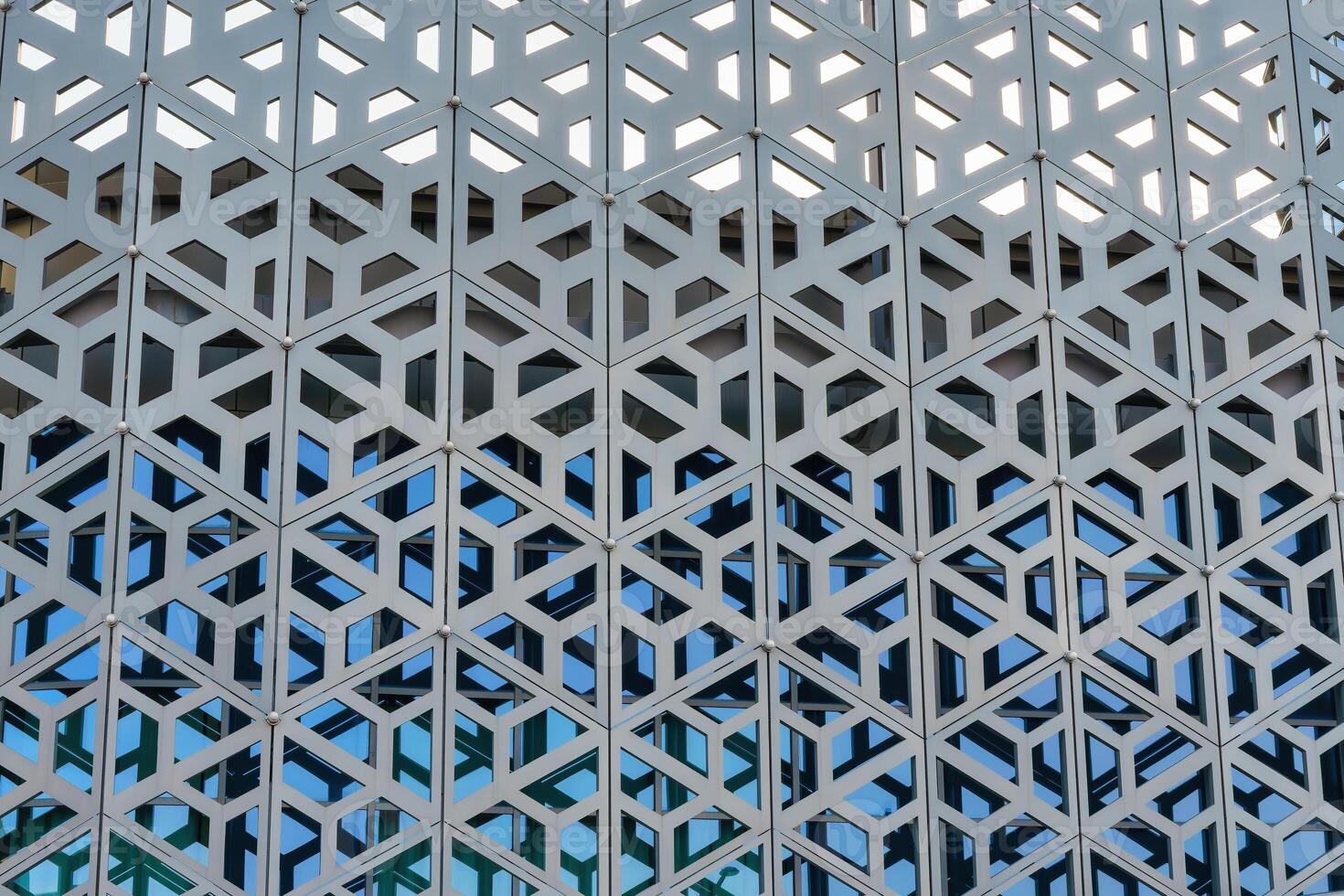 The texture of the cladding of a building made of metal aluminum panels with a carved pattern. Abstract background. photo