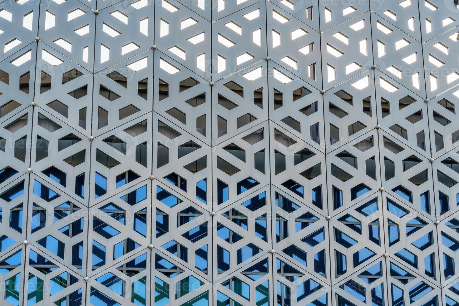 The texture of the cladding of a building made of metal aluminum panels with a carved pattern. Abstract background. photo