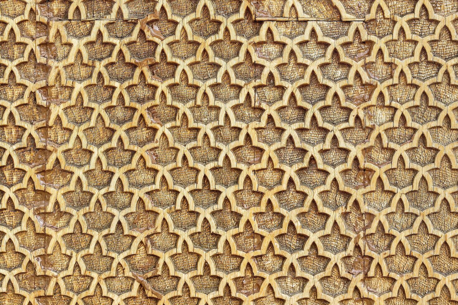 Fragment of an ancient carved wooden pattern. Ornate. Abstract background. photo