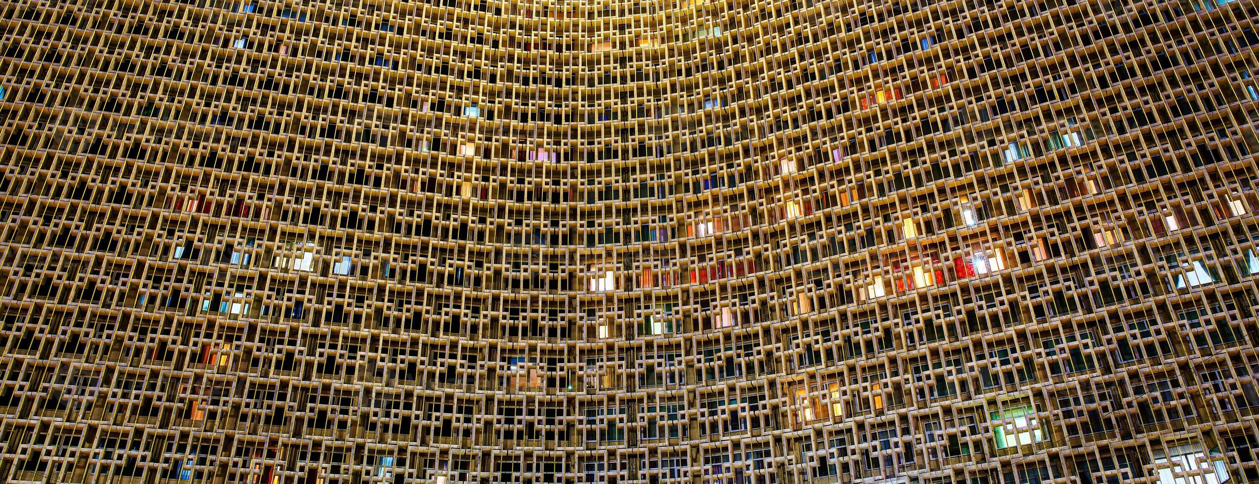 Facade of Uzbekistan Hotel in Tashkent at nighttime. Abstract architectural geometric background. photo